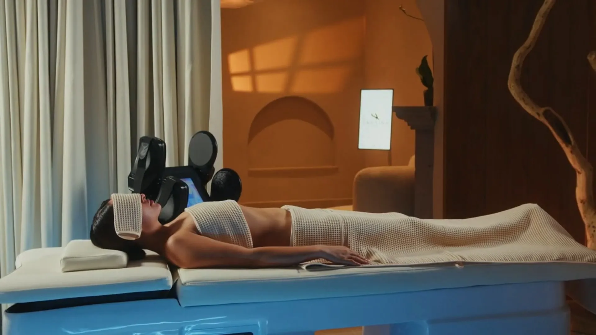 The body treatment room at Santina: white table, lit arch niche and driftwood